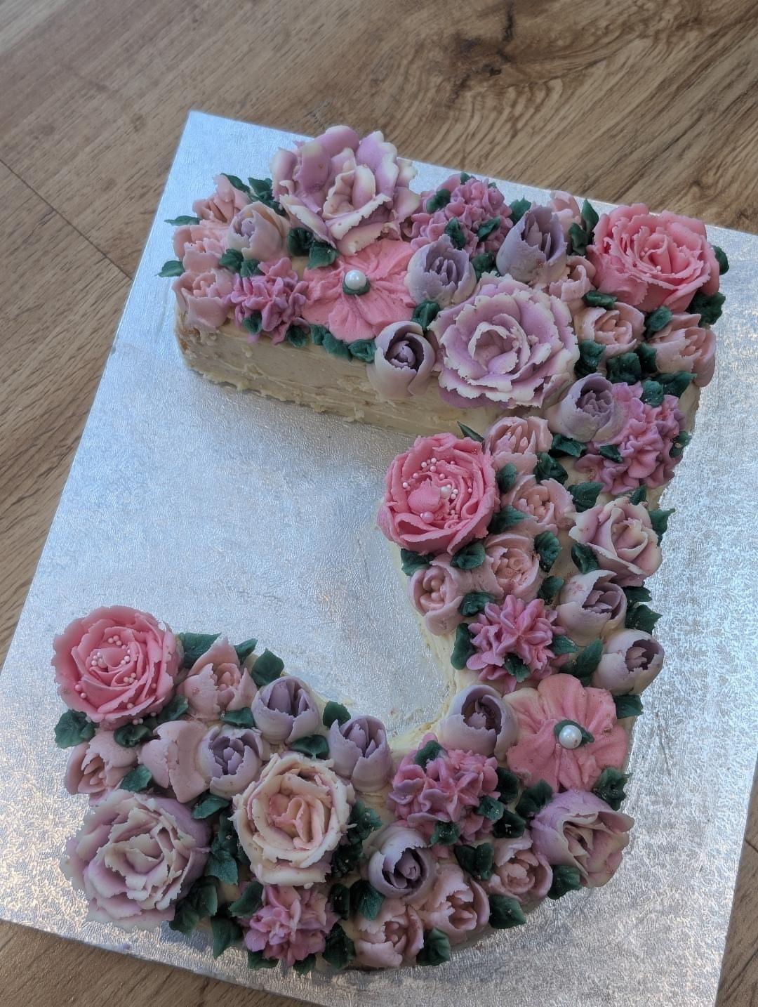 Number 3 cake with buttercream swirls and decorations
